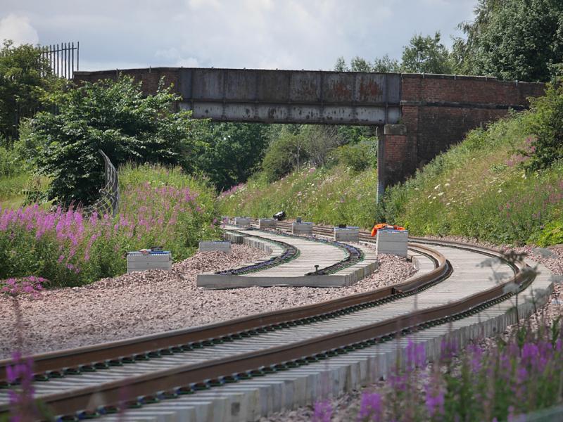 Cameron Bridge track nears: Looking west from alongside the distillery. The Down line has been laid almost to the Leven bridges with the Up line sleepers set out. 29 June. Photo of Cameron Bridge track nears