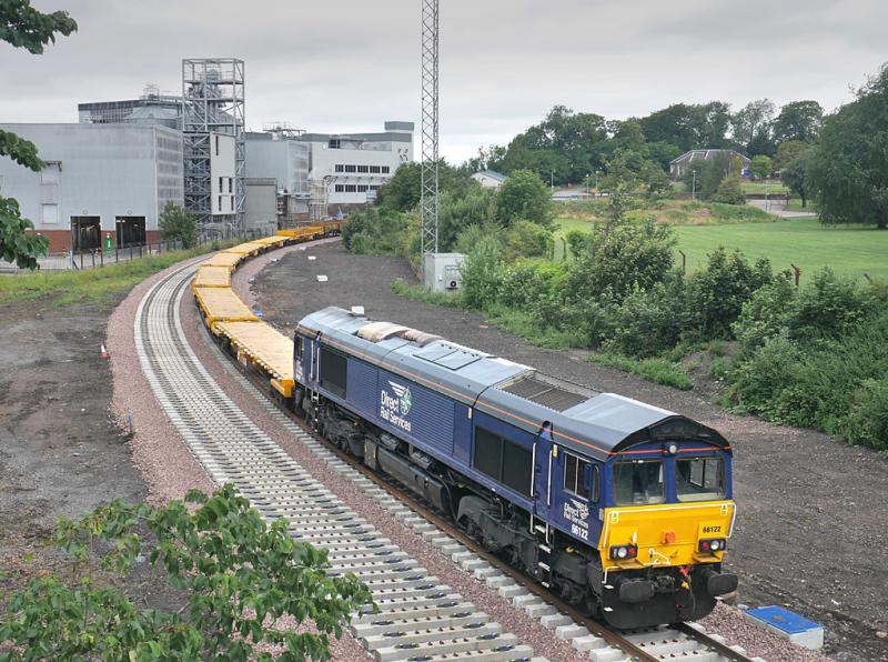 Cameron Bridge 66122: 66122 brings up the rear of the empty concrete sleeper train as it passes through the site of the former station. 7 July Photo of Cameron Bridge 66122