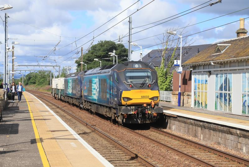 6S43: 68033 + 88007 on 6S43 06.24 Carlisle Kingmoor to Torness Power Stn passing through Prestonpans station on 12/07/2023 Photo of 6S43