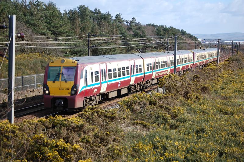 Jumbo train: Train 2K13 Ayr-Glasgow passes Lochgreen. An Atlas air 747 is just visible in the background Photo of Jumbo train