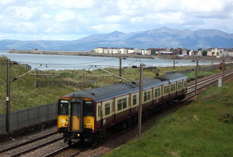 Class 318 and some Peaks: The Peaks are not Classes 44 45 or 46 but the hills of Arran as 318261 takes a Largs-Glasgow train past Saltcoats on 28th May 2007 Photo of Class 318 and some Peaks