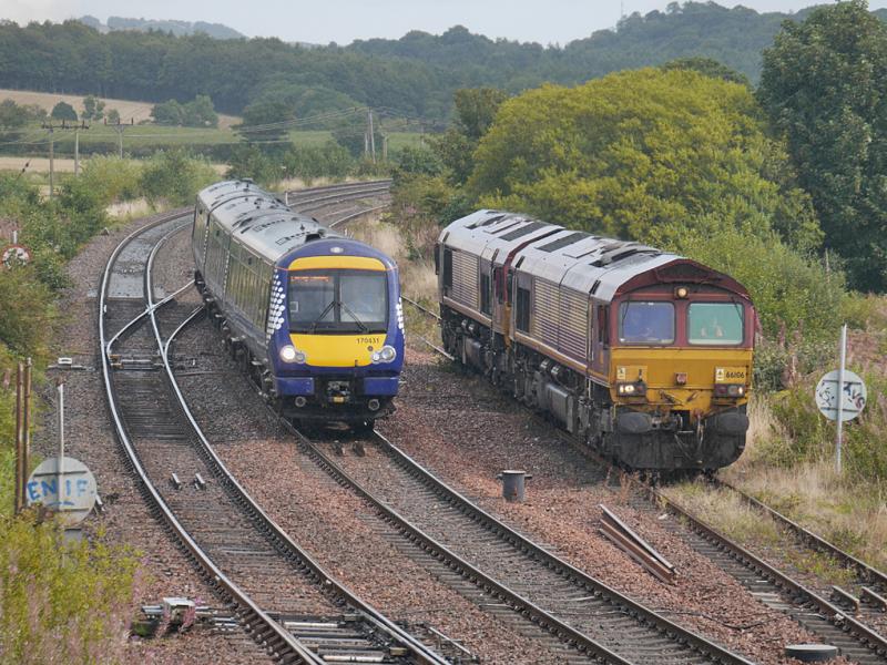Inverkeithing 66s: DBS 66106 and 66053 are passed by 170431 on a local service on their way to Mossend after a week on the Levenmouth branch. 25 August. Photo of Inverkeithing 66s