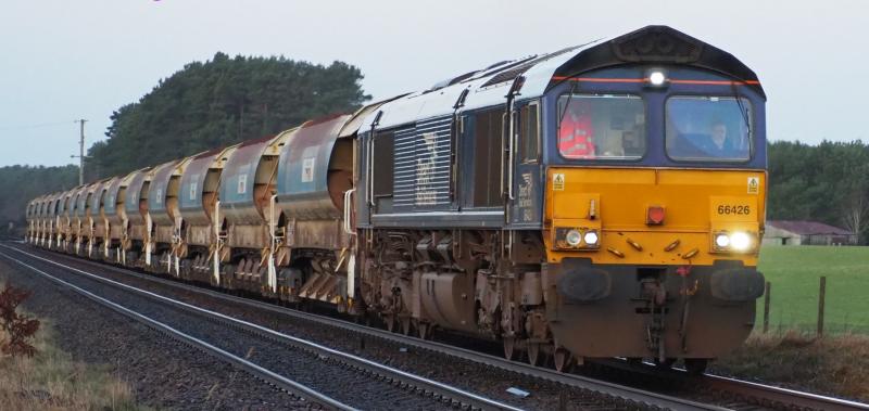 66426 on 15 Autoballasters for MoncrieffTunnel: 66426 passes Bow of Fife Level Crossing on a 6K14 Millerhill to Perth via Dundee ballast turn. 19 Feb 2024 Photo of 66426 on 15 Autoballasters for MoncrieffTunnel