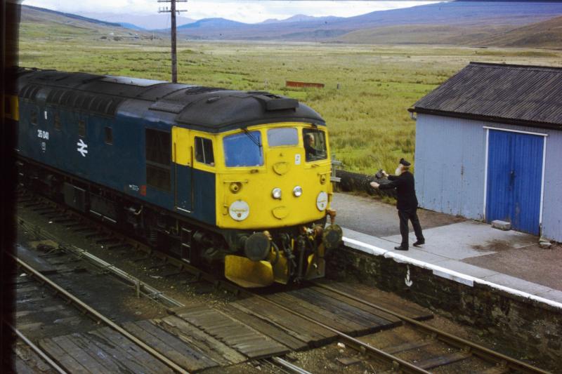 26041 at Achnasheen in 1982: The driver of 26041 swaps tokens with the signalman at Achnasheen, 1982. Photo of 26041 at Achnasheen in 1982