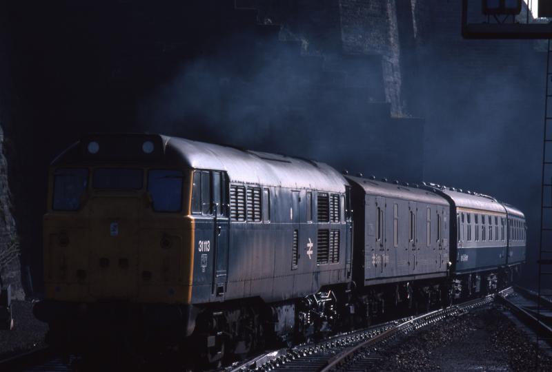 31113 emerges into the light at Waverley: On 16 August 1980 31113 emerges side lit from Calton South tunnel with 1S08, the 0705 Newcastle-Edinburgh with a Mk 1 sleeper in the consist Photo of 31113 emerges into the light at Waverley