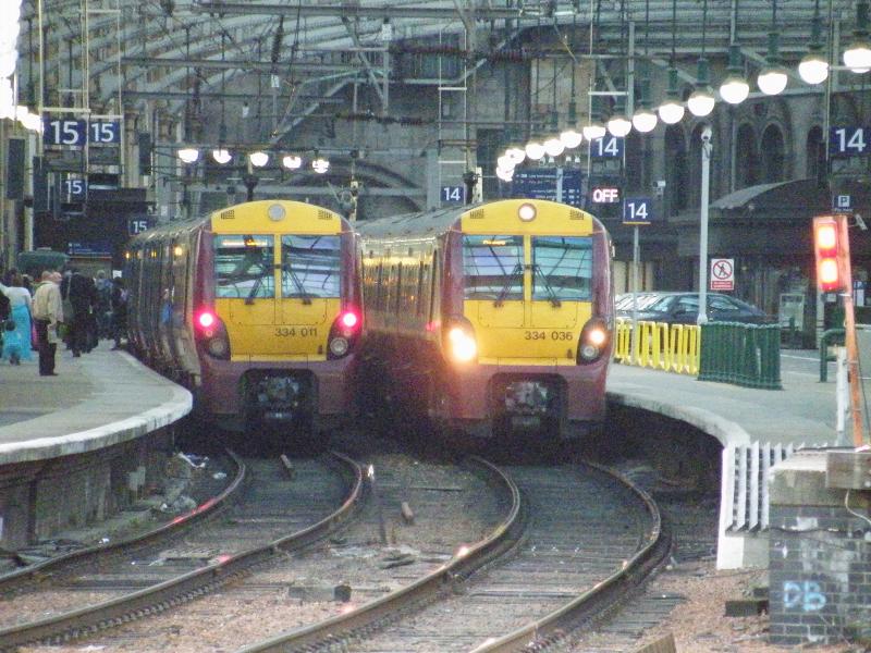 334-011 and 334-036: 334-011 Alighting as 334-036 Sets off from Glasgow central. Note the 'OFF' light illuminated on platform 14. Photo of 334-011 and 334-036