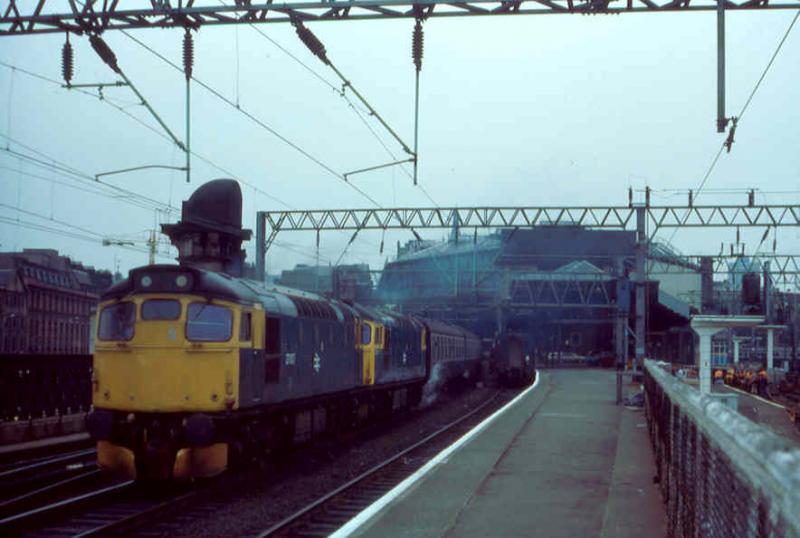 For Stranraer: The Glasgow to Stranraer service became popular with enthusiasts when it went from DMU to loco haulage.
This was taken in 1984 as 27007 and 27014 took the 1135 out of Glasgow Central one morning. Photo of For Stranraer