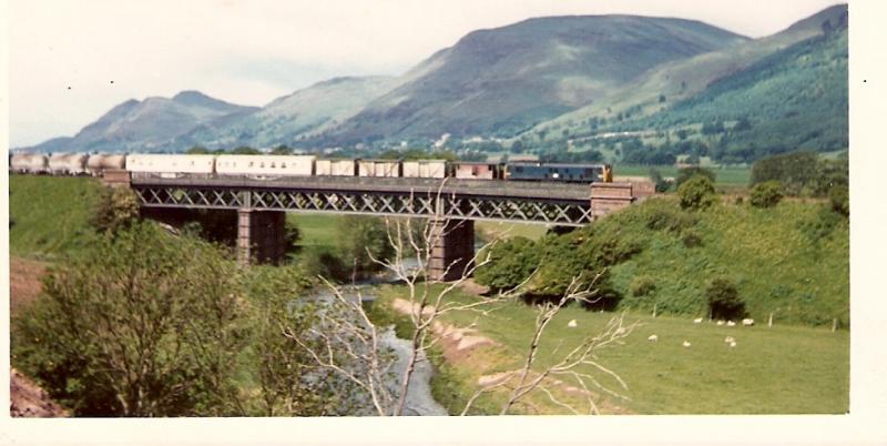 goods over the devon: A goods train traverses the Devon Valley viaduct en route to Perth in the early 1960s. The Ochil Hills provide a spectacular backdrop. Photo of goods over the devon