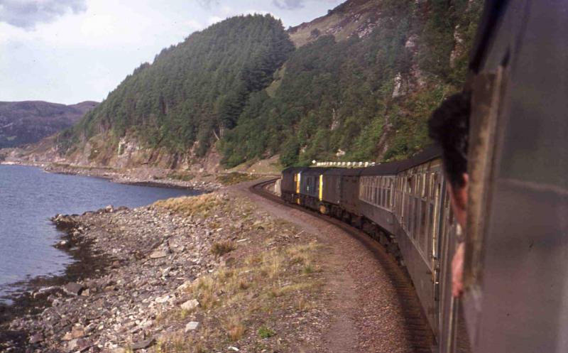 Kyle to Inverness 1974 style: Late afternoon train by Loch Carron. Class 26 + 24 doubleheading - the 24 had (inevitably) developed a fault going over ! The 26 was sent from Inverness to assist. Photo of Kyle to Inverness 1974 style