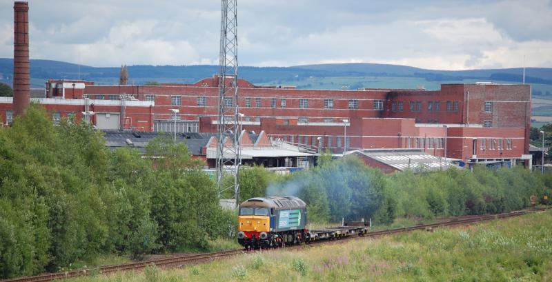 Another variety of 57: THe Johnnie Walker building at Kilmarnock forms the backdrop as 57007 heads for Carlisle (via Lugton) with 4Z31 from brush Barclay. Unfortunately it looks like the 57 could have a longer future than the factory Photo of Another variety of 57