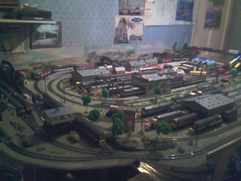areal view of my layout: this is a areal view of my layout to which i am in the process of placing a board under with track for storage of train as im fed up lifting them on and off Photo of areal view of my layout