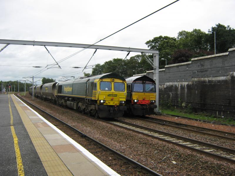 Shed Meets Shed: Freightliner Class 66595 Hauling 4s12 York Holgate to Ravenstruther. Passes 0z26 66422 DRS awaiting the road at Carstairs on the 9th of October 2009 Photo of Shed Meets Shed