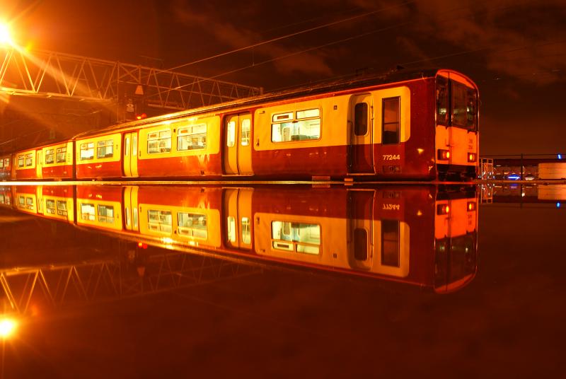 Reflection: First Scotrails 318 254 is seen sitting on a very flooded platform 12 at Glasgow Central on Friday 20th November 2009.(Greig Gibson). Photo of Reflection