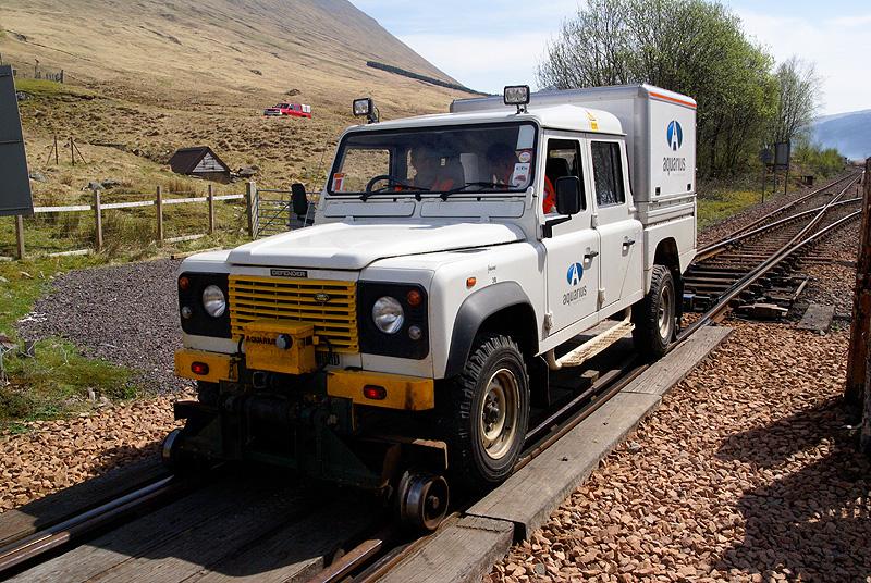 NR traction: A Network Rail road/rail landrover sits at Bridge of Orchy about to depart to Rannoch. Photo of NR traction