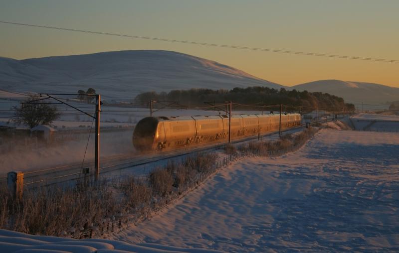 Pendo at Sunset: A Virgin Pendolino catches the last rays of the setting sun as it races south through the snow at Wandel on 07.01.10. Photo of Pendo at Sunset