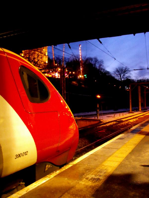Swings and Roundabouts: A Pendolino waits by the Winter Wonderland Photo of Swings and Roundabouts