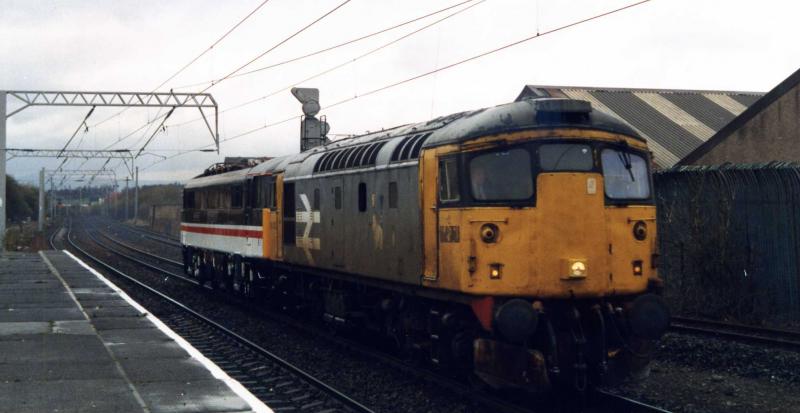 Ready for testing: 26032 heading through Coatbridge Central in March 1993 with 87002 ROYAL SOVEREIGN ex- Works to Mossend for its test run to Carlisle. Photo of Ready for testing