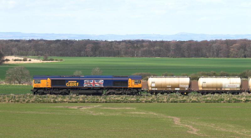 66705 heads 6S44 Alcan tanks near Redhouse Castle, East Lothian: Celebrity 66705 with the Union flag working the North Blyth - Fort William alumina. 15 April 2010 Photo of 66705 heads 6S44 Alcan tanks near Redhouse Castle, East Lothian