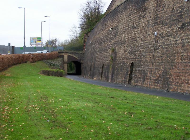 A7 road bridge: Road overbridge (the A7 road) showing previous double track layout modified to support the road - the stonework shows the original arch size. Will the current arch need to be enlarged? Photo of A7 road bridge