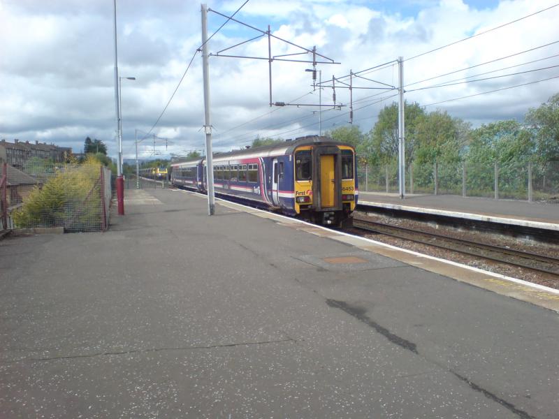 156453 departs from Coatbridge Central: 156453 departs from Coatbridge Central for Cumbernauld whilst 70003 waits at the signal in the background on the 4C07 Longannet - Ravenstruther empties. (27.05.10) Photo of 156453 departs from Coatbridge Central
