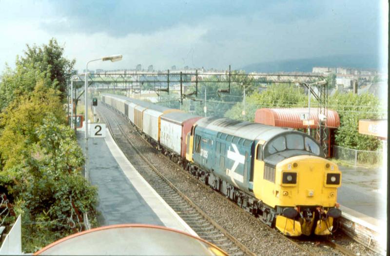 On military duty: Now resident at Bo'ness I believe 37025 INVERNESS TMD passing Drumchapel in September 1994 with a return Photo of On military duty