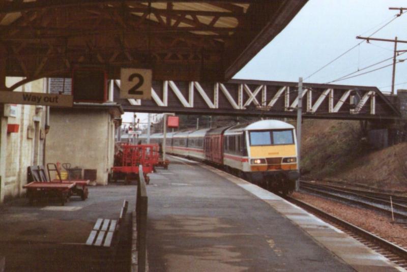 The Royal Scot March 3rd 1990: 90011 heads south through Carstairs. Note all the postal trolleys. Photo of The Royal Scot March 3rd 1990