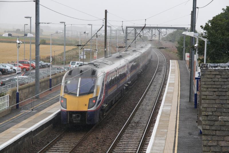 180111 on 5Z80: 180111 on 5Z80 XX.XX Hull to Kilmarnock approaches Prestonpans in a heavy shower which arrived on cue on 20/08/2010 Photo of 180111 on 5Z80