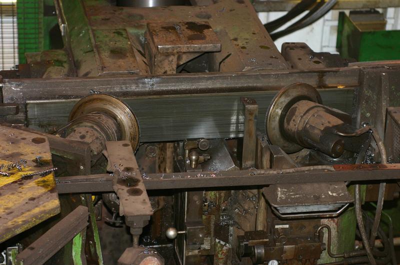 Wheel lathe 2: The inside of the lathe where the operator works his black art. The small discs move in against the wheel and the cutting head come up against the tyre, it is not visible in this shot. Photo of Wheel lathe 2