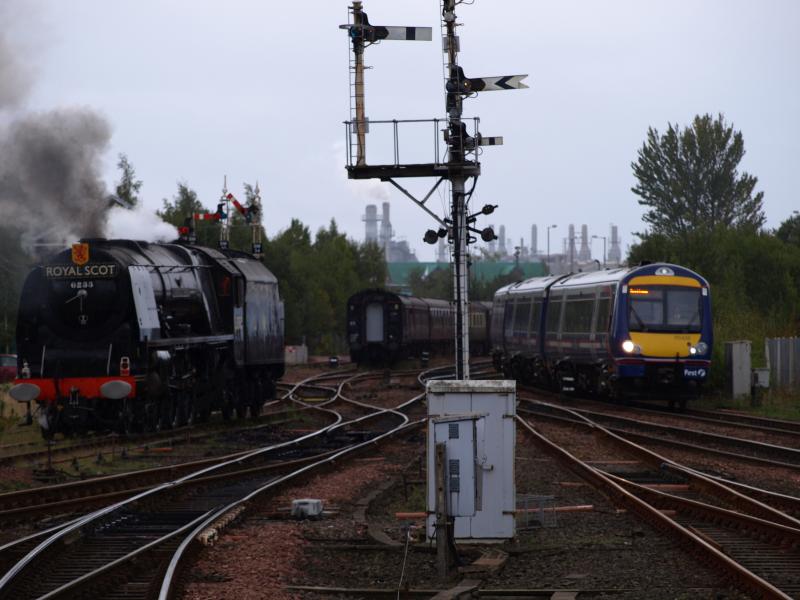 Old and New: 6233 'Duchess of Sutherland' having propelled the stock of 1Z79 into the loop gets the road out of the Stirling Middle yard to head south to Greenhill Upper junction to turn via Polmont. A class 170 passes by northbound. Photo of Old and New