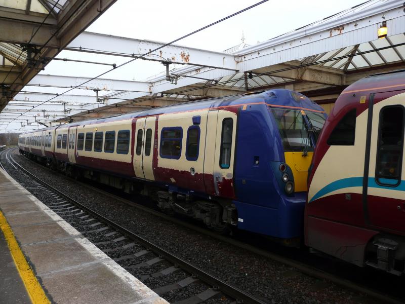 Multi-coloured Class 334 at Troon: 334006 is pictured in a rubbed down state at Troon at 3.40 pm on 3 November 2010 while on the 1K27 service from Glasgow to Ayr with 334004 leading. Photo of Multi-coloured Class 334 at Troon