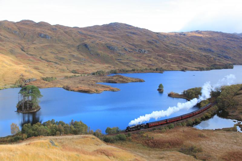 Loch Eilt, Autumn: 44871 takes The Jacobite over the causeway at Loch Eilt on 19/10/10, with a patch of blue sky reflected in the loch. Photo of Loch Eilt, Autumn