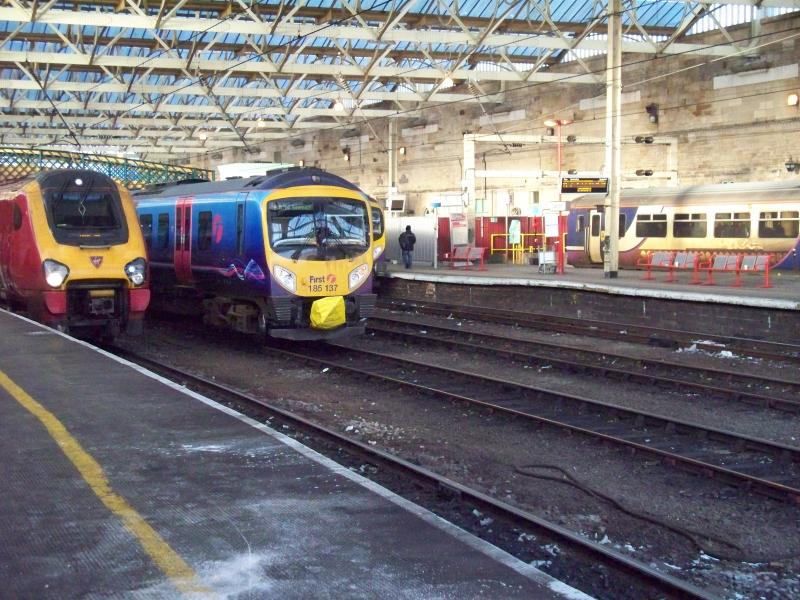 Photo of First TP Express 185137 which failed around Shap Summit on a service from Manchester Airport sits at Carlisle next to a southbound Super Voyager