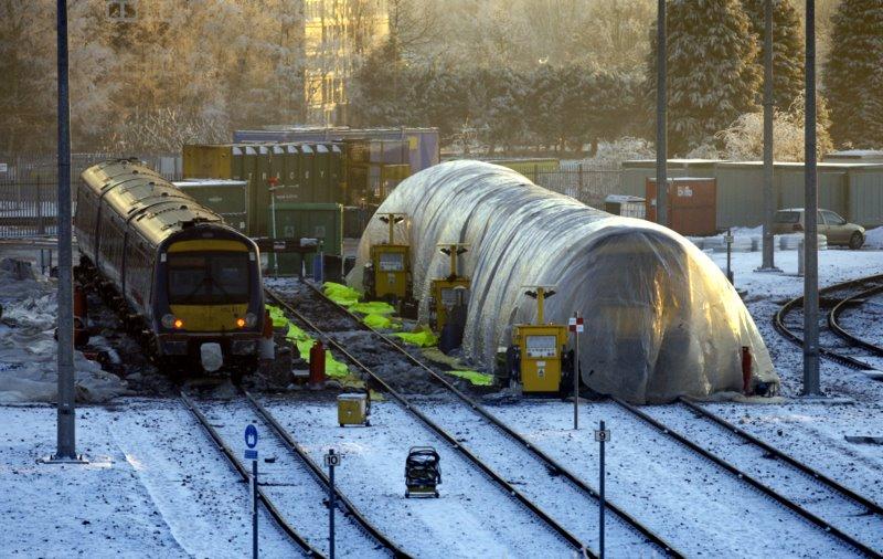 Class 170 Wrapped in Plastic: Class 170 unit at Eastfield under plastic tent presumably as a response to the winter freezing problems with this class. Photo of Class 170 Wrapped in Plastic
