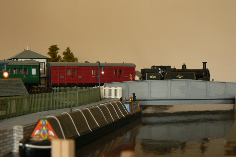M7 crossing swingbridge: . . a reminder to those of us from north of the border than there are railways down south !! . . mind you the loco was designed by Dugald Drummond . . . . a scot !! Photo of M7 crossing swingbridge