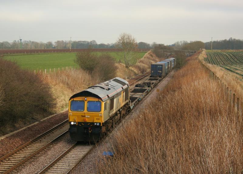 Fastline 66434 4A13 Craigo :
66434 still in Fastline livery passes Craigo on 16th March 2011 while working a lightly loaded 4A13 Grangemouth to Aberdeen Photo of Fastline 66434 4A13 Craigo