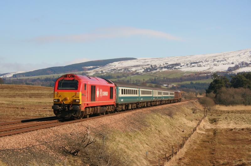 DB Schenker 67018 Blackford:
67018 in DB pink leads 5B24 Perth to Millerhill (clean?) coaches with 67004 on the rear, the pair are seen passing Blackford on 16th March 2011 running about 20 minutes early Photo of DB Schenker 67018 Blackford