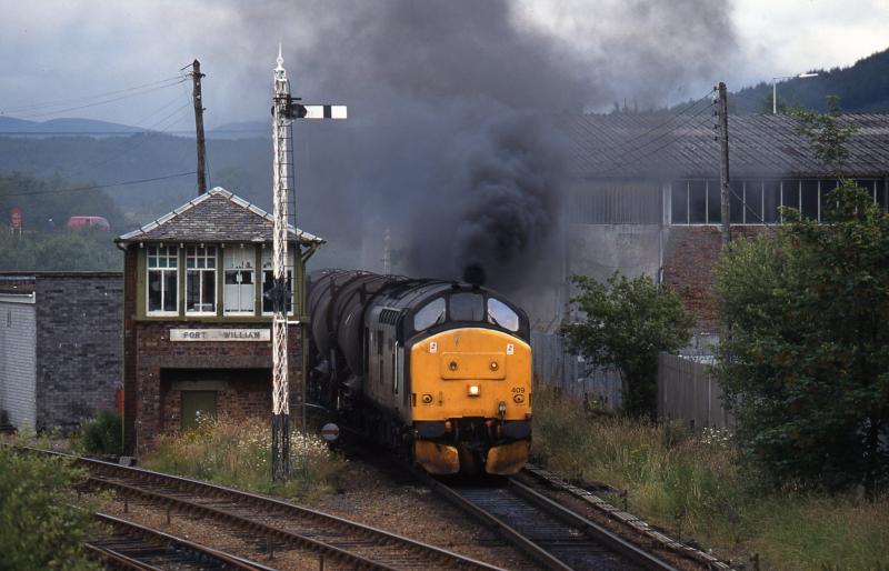 Eh lad, there's trouble at Bill: Having toiled along laying down a smokescreen for miles and miles, a rather troubled 37409 staggers into Fort William with the afternoon freight on 2nd August 1996. Photo of Eh lad, there's trouble at Bill