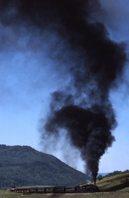The highest today?: Under a clear blue sky, a Cumbres and Toltec 2-8-2 pounds up from Chama towards the summit of the line to Antonito in August 1988 Photo of The highest today?