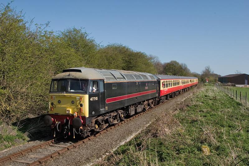 47715 near Leyburn: Wensleydale resident and ex-Scottish 'shove' loco 47715 saunters past the farm crossing beneath Leyburn cemetery whilst working the 13:16 Leeming Bar to Redmire service, Fri 8/4/11. Photo of 47715 near Leyburn