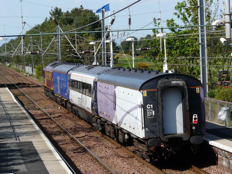 East Coast delivery from Kilmarnock: 67026 heads wrong line through Barassie with a newly reburbished East Coast coach sandwiched between two colourful barrier coaches on 26 April 2011. Photo of East Coast delivery from Kilmarnock