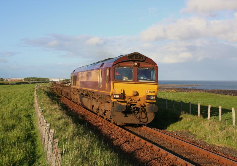 66099 Brora 6E69 Georgemas Junction to Tees Yard:
66099 departs from Brora with 6E69 Georgemas Junction to Tees Yard empty pipe carriers and spacer wagons on 18th May 2011 Photo of 66099 Brora 6E69 Georgemas Junction to Tees Yard