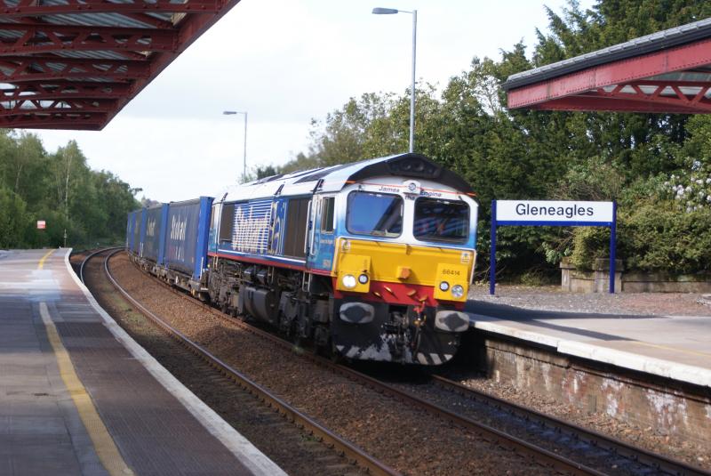 66414 - James the Engine: 66414 , in Carlisle-based Stobart Rail livery , rushes through Gleneagles Station in rural Perthshire on it's return leg from Inverness at about 16:45 on the 28th May. Photo of 66414 - James the Engine