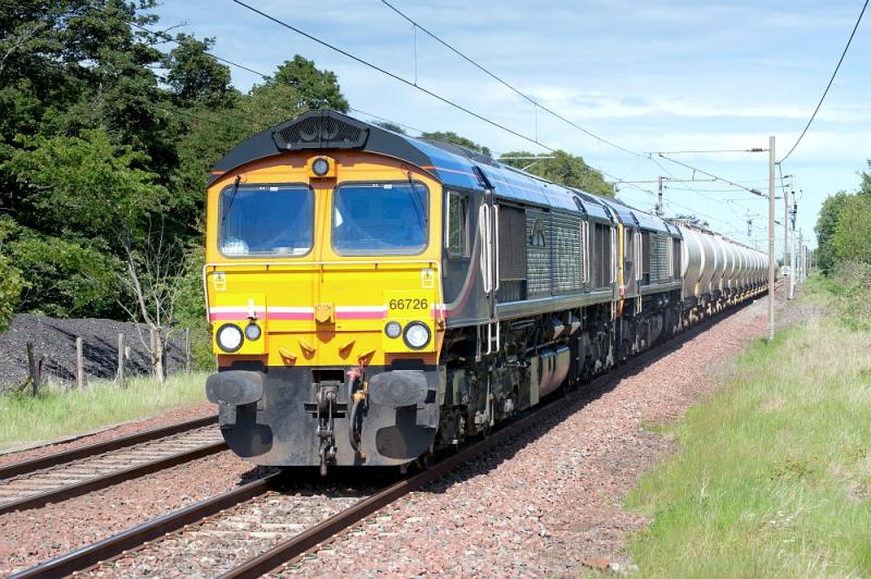 Alcan Froth: Whilst many are chasing the Deltic round Fort William in the rain, here are 66726 + 66723 with the loaded Alcan tanks, approaching Longniddry in full sun. 30 May 2011.
KS thinking of all the petrol saved by staying local! Photo of Alcan Froth