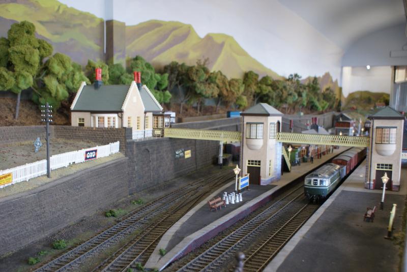 Glenauchter: Trying to catch tiny double 00 guage can be testing at times.This Bo'ness model set-up resembles the real Gleneagles Station. A Crompton is hauling goods , is halted at the platform. Photo of Glenauchter