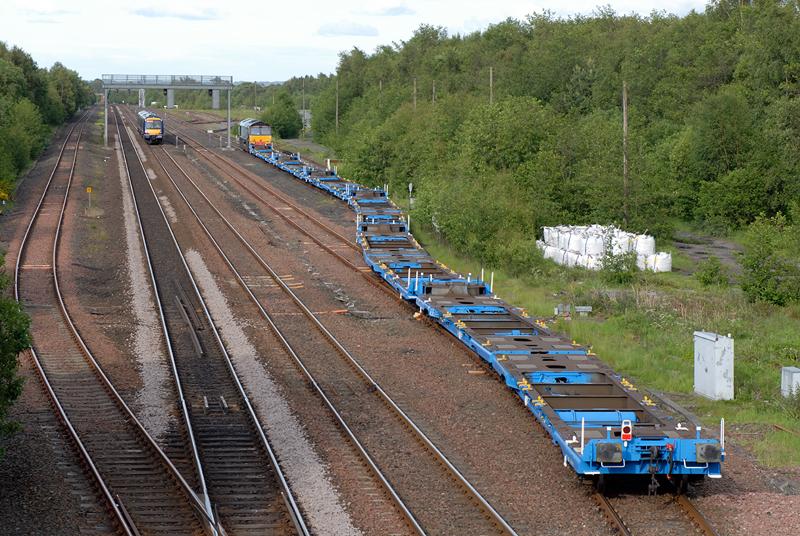 Cadder flat wagons: DRS 66416 on the 4Z22 Trafford Park - Cadder Yard, photographed entering Cadder Yard from Bishopbriggs on the down line. Taken on Thursday 9th June 2011 at 19:02. Photo of Cadder flat wagons