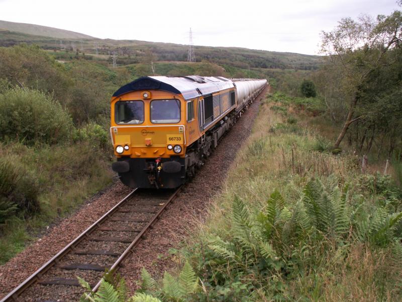 Tinfoil & Traction: New liveried GBRF 66733 effortlessly trundles up the hill northbound through Whistlefield with the loaded 6S45 Blyth to Fort William Alcan working today. Photo of Tinfoil & Traction